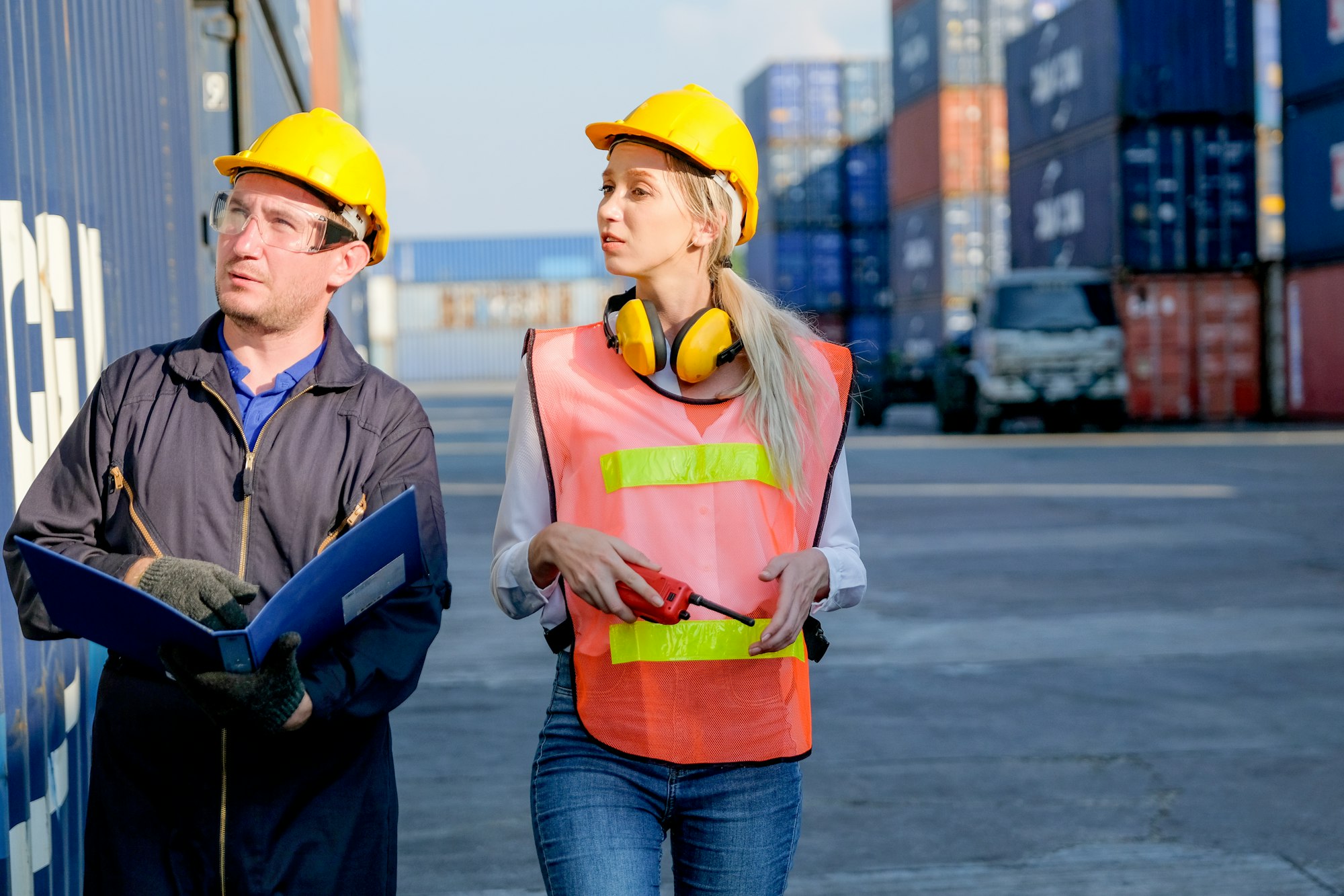 Technician or workers man and woman discuss about the product in cargo container